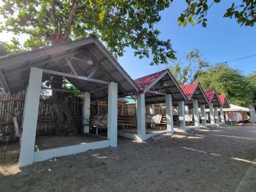 a row of pavilions under a tree at Yemaya de Laiya powered by Cocotel in Batangas City