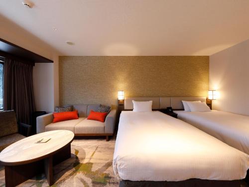 Ein Bett oder Betten in einem Zimmer der Unterkunft Executive Suite SUIREI