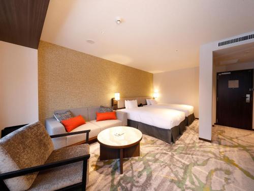 Ein Bett oder Betten in einem Zimmer der Unterkunft Executive Suite SUIREI