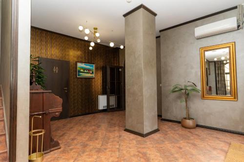an office lobby with a pillar and a potted plant at Hotel DEMETRA in Berkovitsa