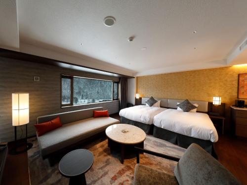Ein Bett oder Betten in einem Zimmer der Unterkunft Executive Suite SUIREI
