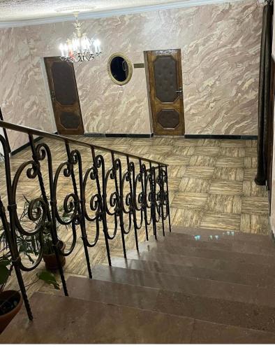 a set of stairs with a chandelier on the wall at Baron Hotel in Vanadzor