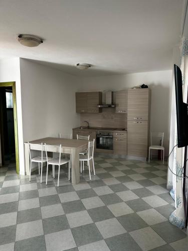 a kitchen with a table and chairs in a room at Su Coru Budoni in Budoni