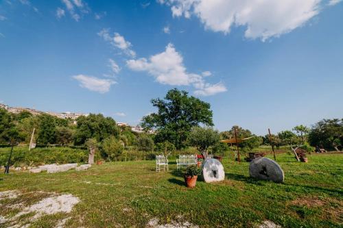 a field with two large rocks in the grass at Tenuta Le Tre Rose in Vibonati