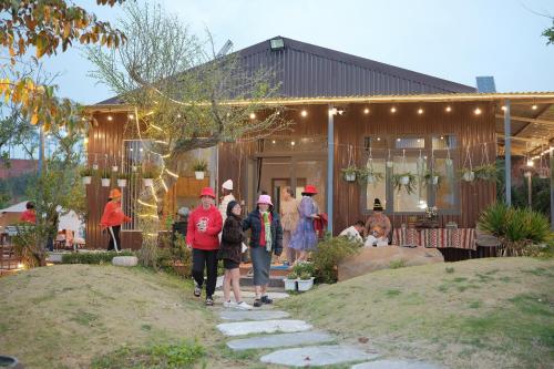 a group of people walking in front of a building at Mountain Nest Villa Dalat - BBQ, Cloud Hunting, Camping in Da Lat
