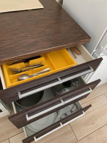 a kitchen counter with a wooden table with tools at Panda apartman in Esztergom