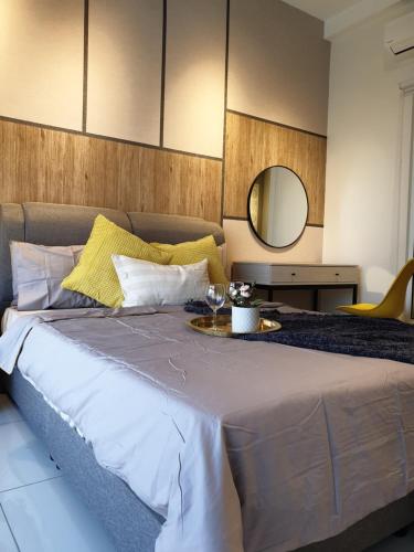 a bedroom with a bed with a table and a mirror at Arte Mont Kiara Studio,Kuala Lumpur in Kuala Lumpur