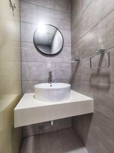a bathroom with a white sink and a mirror at Arte Mont Kiara Studio,Kuala Lumpur in Kuala Lumpur