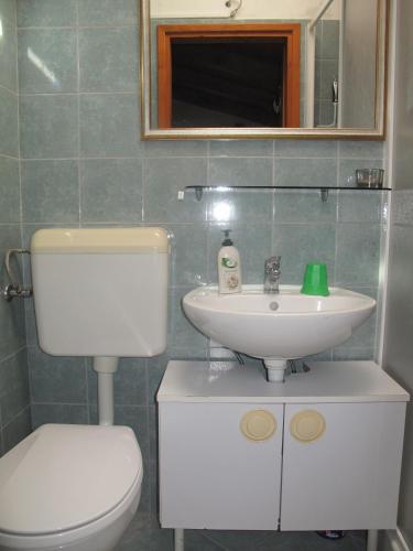a bathroom with a toilet and a sink at La Calletta in Rovinj