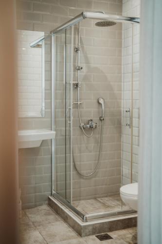 a shower with a glass door in a bathroom at Ktima Papadopoulou in Krionérion