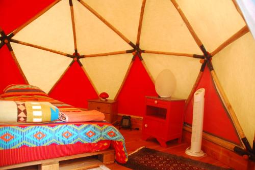a room with a bed in a yurt at Tente tipi nature, calme, cascade et baignade à 10 minutes à pieds in Saint-Laurent-le-Minier
