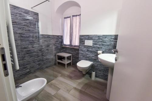a bathroom with a sink and a toilet and a sink at VILLA IRMA in Varigotti