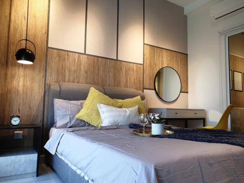 a bedroom with a bed with a mirror on the wall at Arte Mont Kiara Studio,Kuala Lumpur in Kuala Lumpur