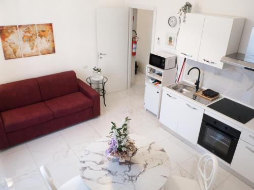 ein Wohnzimmer mit einem roten Sofa und einem Tisch in der Unterkunft De Camillis Apartments in St Peter in Rom