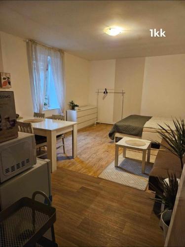 a room with a bed and a table and a bed and a desk at Ubytování v soukromí in Choustníkovo Hradiště