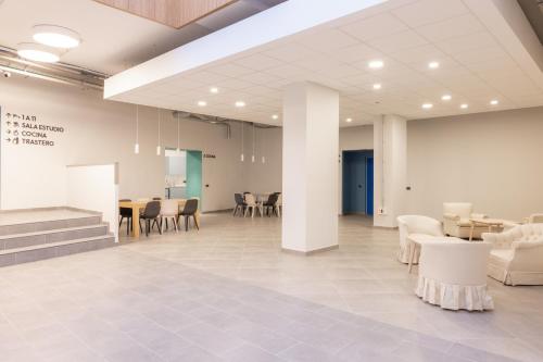 a lobby with white furniture and tables and chairs at E16 - Estudio La Orotava in La Orotava