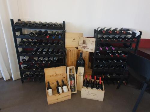 a bunch of bottles of wine sitting on the floor at L'Alberghetto Le Dimore Di Contrasti in Castiglione dʼOrcia