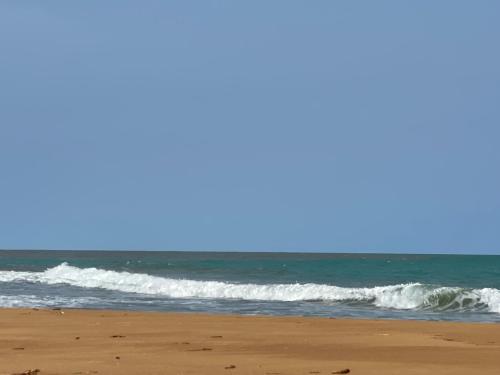 an image of the beach with waves in the ocean at Village Kirikou in Grand-Popo