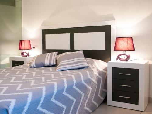 een slaapkamer met een groot bed met twee lampen bij Vista Bella in Torrevieja