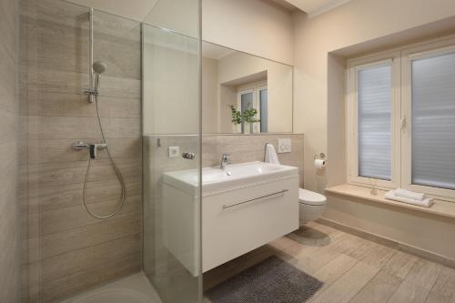 a bathroom with a shower and a sink and a toilet at Luxury 4 star apartment in the Old Town Zadar in Zadar