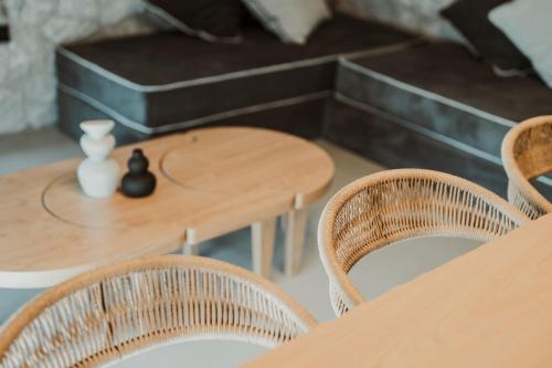 a wooden table with chairs and a table and a table and chairsktop at Ktima Papadopoulou in Krionérion