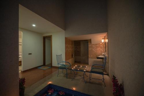 a living room with a glass table and chairs at Clarks Safari Ranthambore in Khilchipur