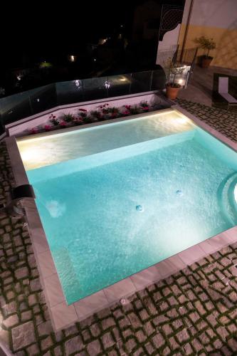 a large swimming pool with a light in the middle at Palazzo San Giovanni Amalfi Coast in Scala