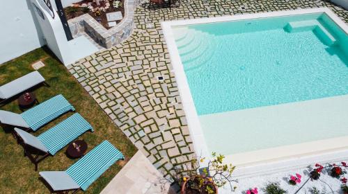 an overhead view of a swimming pool with two chairs at Palazzo San Giovanni Amalfi Coast in Scala