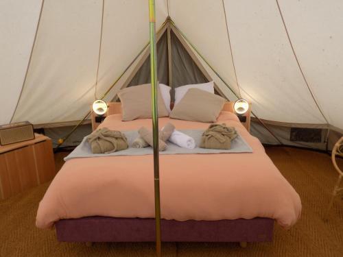 a bedroom with a bed in a tent at Tente familiale au bord de l'eau in Le Vigeant