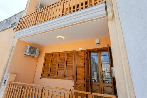 a balcony of a house with a door and a window at Art House - Big & Artistic Design House in Minervino di Lecce