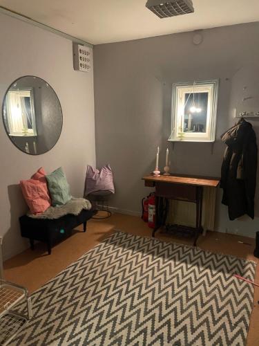 a living room with a piano and a mirror at Stuga med egen brygga in Fagersta