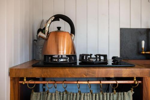 a tea kettle sitting on top of a stove at The Hyde in Cuckfield
