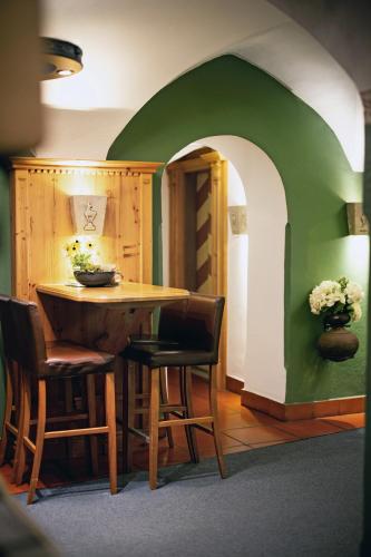 a dining room with a wooden table and chairs at Eggerwirt Kitzbühel, Hotel & Restaurant in Kitzbühel