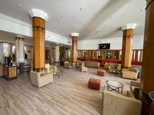 a large lobby with couches and tables and columns at Marina Palace in Hammamet