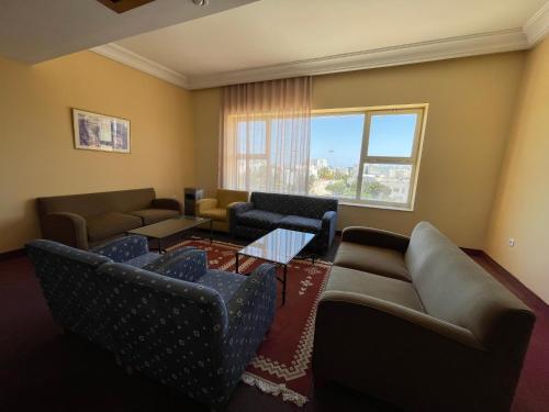 a living room with couches and chairs and a window at Marina Palace in Hammamet