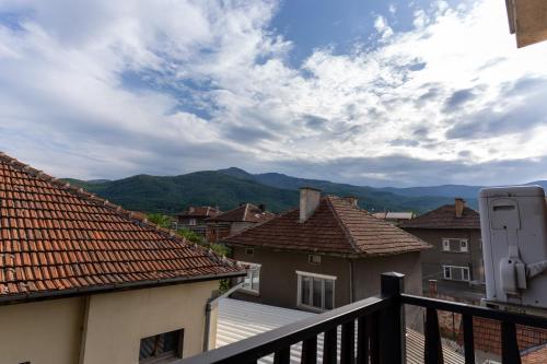 a view from a balcony of houses and mountains at Hotel DEMETRA in Berkovitsa