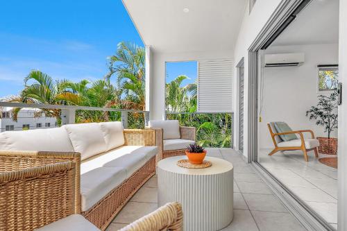 a living room with a couch and a table at Retreat in the Heart of Alex - 3BR sleeps 11, Pool in Alexandra Headland