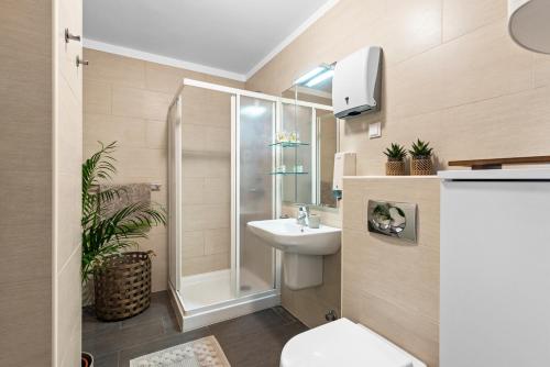 a bathroom with a shower toilet and a sink at GRAND CENTRAL apartment with 3 bedrooms in Porec! in Poreč