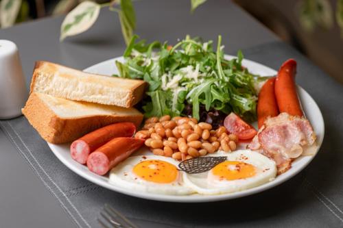 a plate of breakfast food with eggs bread and vegetables at Black Sea Central in Odesa