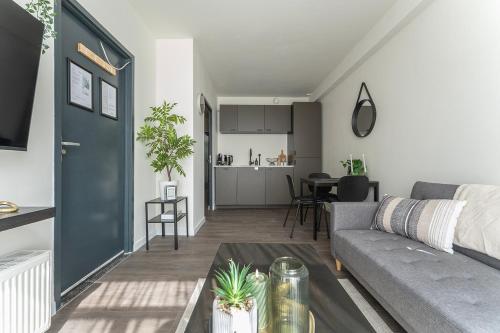 a living room with a couch and a table at Modern Stay with Wi-Fi - Tilburg in Tilburg