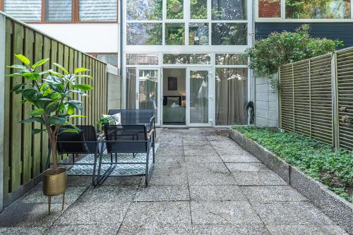 a patio with chairs in front of a building at Modern Stay with Wi-Fi - Tilburg in Tilburg