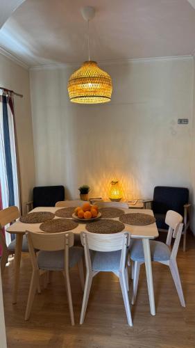 a dining room with a table and some chairs at Margarida Guest House - Rooms Lisbon South by Rosado in Almada