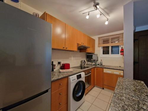 a kitchen with a washer and a dishwasher at Genista house Peyia in Peyia