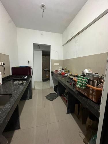 a kitchen with a long counter in a room at Apartment in Antarli in Mangrul