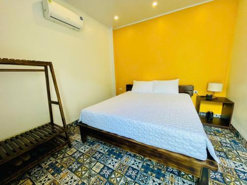 a bedroom with a bed and a mirror at Tam Coc Hope House in Ninh Binh