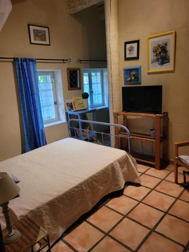 une chambre avec un lit et une télévision à écran plat dans l'établissement Appartement familial à Arles avec jardin et piscine, à Arles