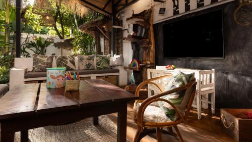 a living room with a wooden table and a couch at Babel Siem Reap Guesthouse in Siem Reap