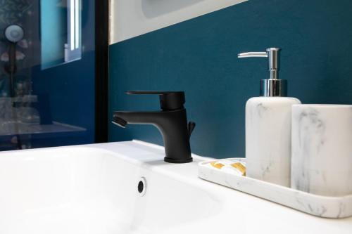 a bathroom sink with a soap dispenser on it at Casa del lago in Oggebbio