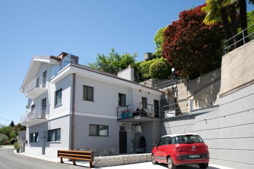 a red car parked in front of a building at Casa del lago in Oggebbio