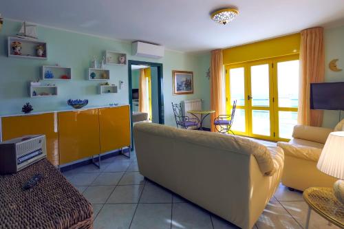 a living room with a couch and a tv at Villa Le Porpore in Furore